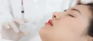 Woman undergoing skin booster injection treatment